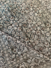 Load image into Gallery viewer, Close-up view of an antique Tabriz rug showcasing intricate floral patterns and a variety of muted colors including green, blue, beige, and brown.
